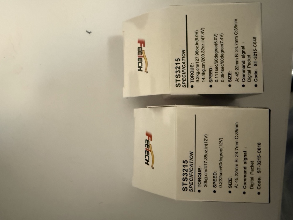 Two servo boxes: ST-3215-C018 rated 30 kg&middot;cm at 12V, and ST-3215-C046 rated 14.4 kg&middot;cm at 7.4V.